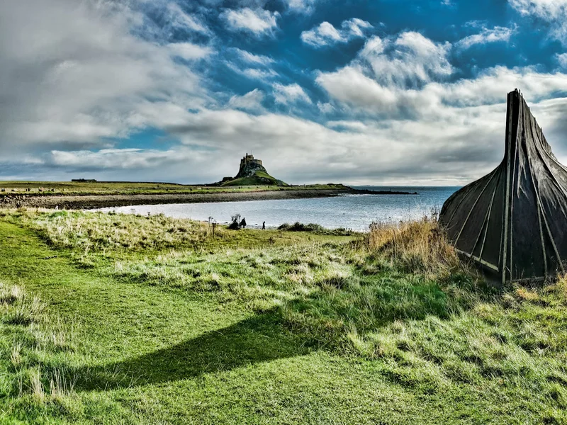 A Grassy Area Next to a Body of Water. Lindisfarne, Berwick-upon-Tweed