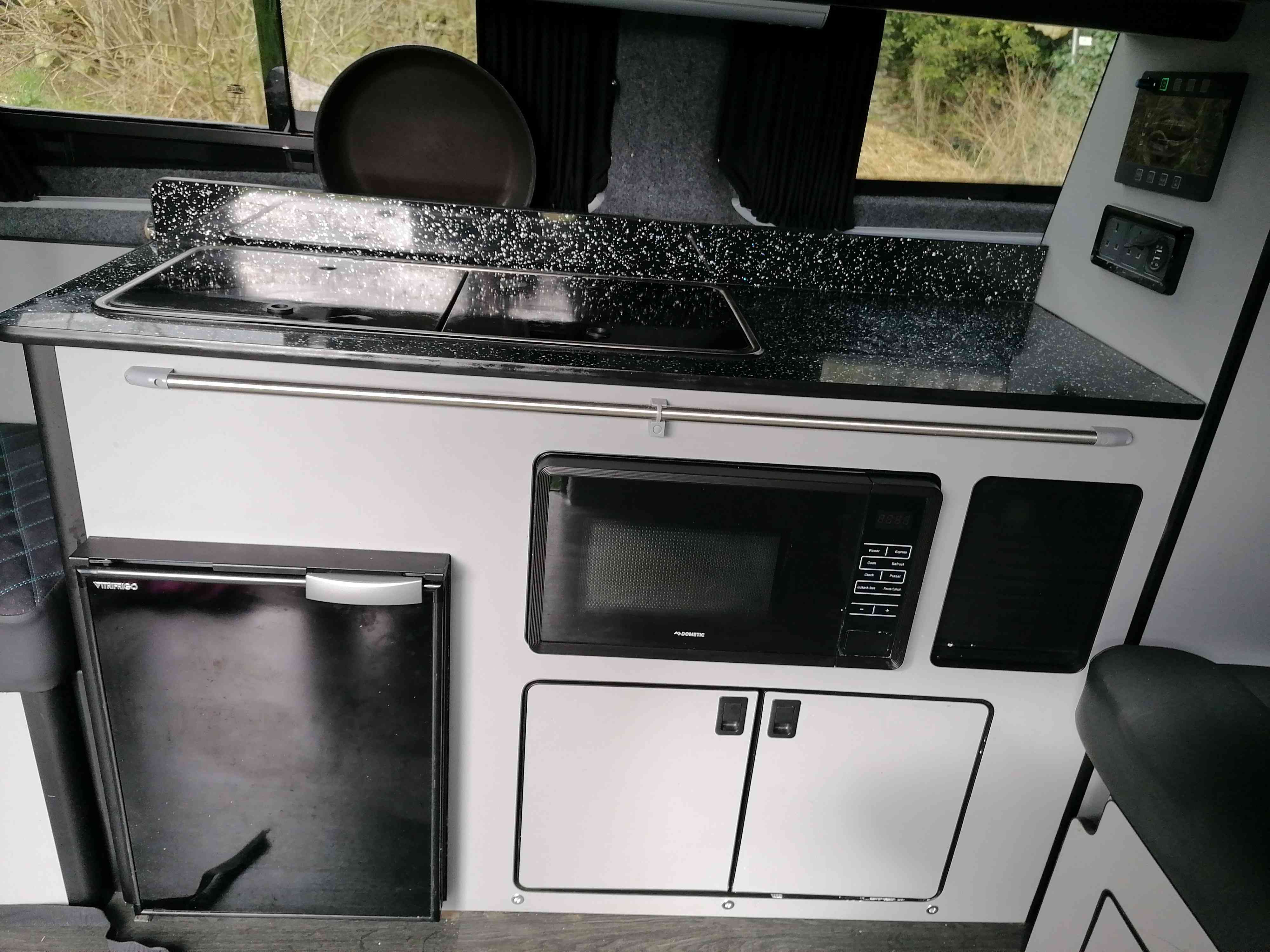 A Ford Campervan called Joyride and The kitchen has a fridge-freezer, microwave and plenty of storage. for hire in Walsall, West Midlands
